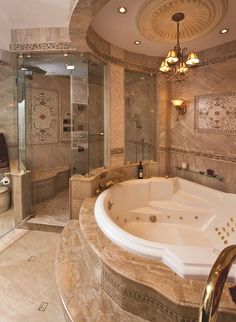 a bathroom with a large jacuzzi tub and walk in shower