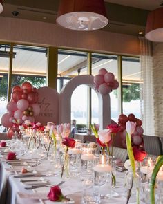 a long table is set up with candles and balloons for a wedding or special event