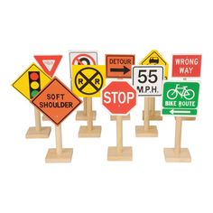 a set of five wooden road signs sitting on top of each other in front of a white background