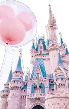 a large pink balloon floating in front of a castle