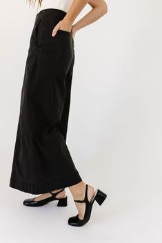 a pair of black wide-leg pants that are sooo good, you’ll never want to take them off. the high-rise + fitted waistline gives it “business casual” charisma, while the flowy loose legs keep things real + relaxed. full of versatility, you can dress them up or down for any occasion. black // wide leg, high waisted, one button zip fly, belt loops, pockets paired with our matilda mesh top + lover denim vest model is 5'8" + wearing a small measurements are approximate + taken while laying flat small : Versatile Wide Leg Spring Dress Pants, Spring Wide Leg Versatile Dress Pants, Versatile Wide-leg Spring Dress Pants, Spring Wide Leg Dress Pants, Black Wide Leg Culottes For Spring, Black Wide-leg Culottes For Spring, Wide Leg Pants For Date Night In Summer, Chic Wide-leg Fall Culottes, Versatile Straight Leg Culottes For Spring