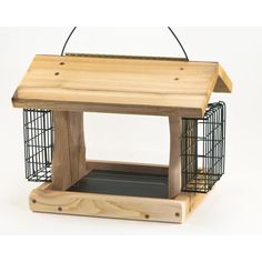 a wooden bird feeder with cage on top