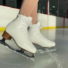 the legs of a person skating on an ice rink