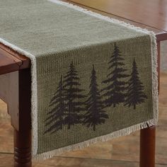 a table runner with pine trees on it