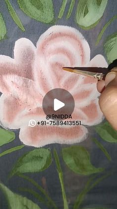 someone is painting a flower with acrylic paint