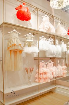 there are many dresses on display in the store