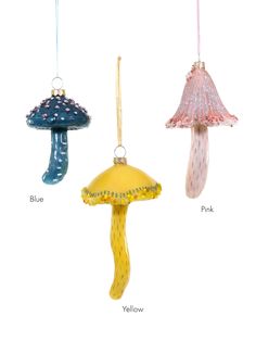 three glass ornaments hanging from strings in different shapes and sizes, each with a mushroom on top