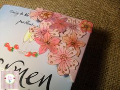 an open book with flowers on the cover