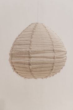 a white paper lantern hanging from a string