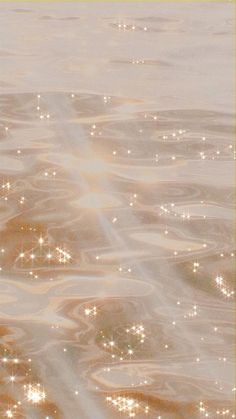 an image of water that is very close to the shore with sparkles on it