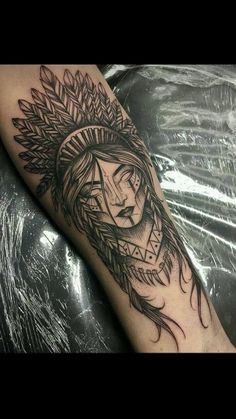 a person with a headdress tattoo on their arm