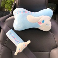 a car seat with a pillow on top of it and an arm rest in the back