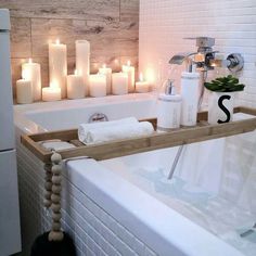 a bath tub with candles on the wall