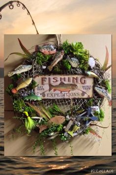 a fishing sign hanging from the side of a wall next to some water and plants