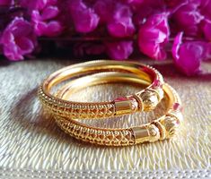 Description Welcome to M S Collections. This is a set of Bangles Bracelets with Gold Plated finishing. This beautiful set can be worn at any occasion such as party, wedding Engagement ceremony. Bangles Size - 2.6 Inches  Free Shipping Service - Indian Postal Service Delivery Timing -  8 To 18 Days Express shipping option is also given with each listing to get your item fast. Do contact me if there is any query. Happy Buying :) Bohemian Bracelets With Intricate Design For Celebrations, Bohemian Gold Bracelets For Puja, Elegant Handmade Bangle For Puja, Elegant Handmade Puja Bangle, Gold Bohemian Bangle For Puja, Adjustable Elegant Bangle For Puja, Bracelet Party, Engagement Ceremony, Gold Plated Bangles