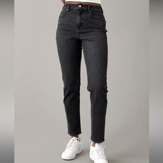 The Same Mom Jean Fit You Know & Love: High-Waisted With A Tapered, Ankle-Skimming Cropped Leg. Rigid In The Front. Stretchy In The Back. Magic All Over With Innovative 50/50 Construction Made With Rigid Denim In The Front Of The Leg & Stretch Denim In The Back. The Vintage Look Of 100% Cotton Denim, But With The Comfort And Ease Of Your Favorite Stretchy Pants. Black Wash Mom Jean Fits, Jean Fit, Stretchy Pants, Mom Jean, Leg Stretching, American Eagle Outfitters Jeans, Pants Black, 50 50, Colored Jeans