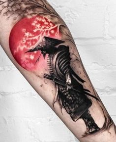 an arm with a black and red tattoo on it