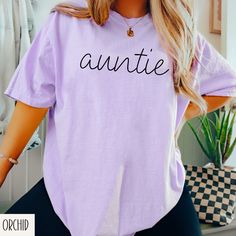 Auntie Shirt, Aunt Gift, New Aunt Gift, Aunt Life Shirt, Promoted to Aunt Shirt, Gift for Auntie, Sister Gift, Pregnancy Announcement Tee DETAILS & FABRIC: Design is printed on a soft, heavyweight garment-dyed unisex T-shirt.  - Made using 100% US ring-spun cotton that is ethically grown and harvested.  - Thick, but breathable material - Garment-dyed - 7/8″ double-needle topstitched collar - Twill-taped neck and shoulders for extra durability - Double-needle armhole, sleeve, and bottom hems SIZING & FIT: - Relaxed fit - Pre-shrunk - Recommend sizing up 2 sizes for more loose/oversized fit - Exact dimensions and size chart are listed in the item photos - Rolled sleeves are for styling purposes only **Colors of final product may vary slightly based on differences in monitor & photo lighting. Purple Crew Neck Top With Name Print, Promoted To Aunt, Aunt Shirt, Aunt Life, New Aunt, Auntie Shirts, Aunt Shirts, Rolled Sleeves, Aunt Gifts