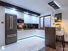 a modern kitchen with white cabinets and stainless steel appliances