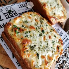 two slices of pizza sitting on top of a wooden cutting board