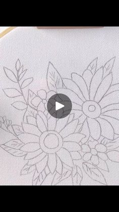 someone is drawing flowers on paper with markers