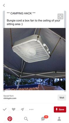 a white fan sitting on top of a tent