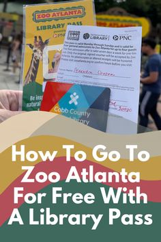 someone holding up a book with the title how to go to zoo atlanta for free with a library pass