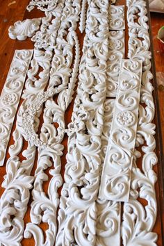 some white carvings are laying on the floor