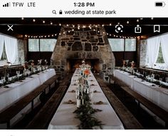 a long table is set up in front of a stone fireplace