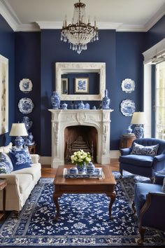 a blue and white living room with two couches, a coffee table and a chandelier