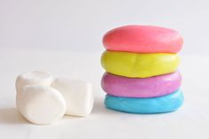 a stack of donuts and marshmallows sitting next to each other on a white surface