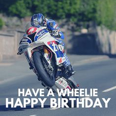 a man riding on the back of a motorcycle down a curvy road with words that say, have a wheelie happy birthday