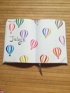 an open notebook with hot air balloons on it