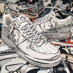 a pair of white nike air force sneakers sitting on top of graffiti covered wallpaper