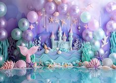 an image of a mermaid themed birthday party scene with balloons and sea animals in the background