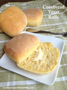 two loaves of bread on a plate next to a fork and spoon with the words cornbread yeast rolls