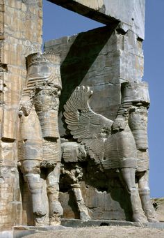 two ancient statues are shown in front of a stone structure with an eagle on it's back