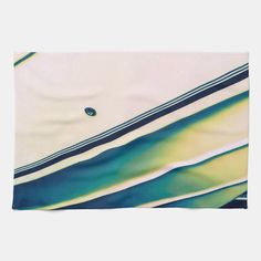 an abstract painting with blue, green and yellow stripes on it's edges is featured against a white background