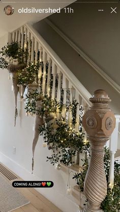 the stairs are decorated with greenery and lights