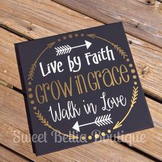 a sign that says live by faith, growing grace and walk in love on a wooden bench