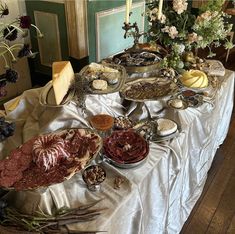 an assortment of meats and cheeses on a table