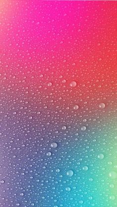 water drops on the surface of a rainbow colored background