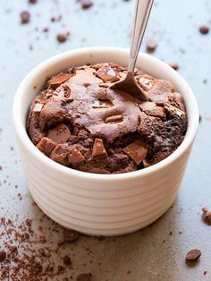 a spoon in a bowl filled with chocolate cake