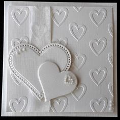 a card with two hearts on it and some white paper in the shape of a heart