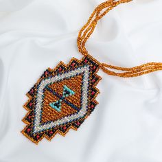 Trendy and tribal-inspired, the Mayan Pyramid Beaded Pendant Necklace makes a bold statement. Perfect for pairing with whites or denim for a great boho look. Made by women artisans of La Casa in Guatemala. Since 2000, La Casa Cotzal has designed a range of Guatemalan handcrafted pieces produced by artisan communities throughout the country. Mayan women traditionally have been backstrap loom weavers, but increasingly they are learning to use pedal looms as well. In traditional Guatemalan weaving, the two main specialized techniques are ikat and supplementary weft brocade. Artisans at La Casa are versed in both weaving techniques as well as in intricate bead work. The work provided by La Casa is vital to the women's families and communities. Glass beads & cotton thread Pendant: 3.25" H x 2" Guatemalan Weaving, Mayan Women, Paw Print Jewelry, Spirit Clothing, Backstrap Loom, Fair Trade Clothing, Ribbon Jewelry, Fair Trade Jewelry, Printed Jewelry