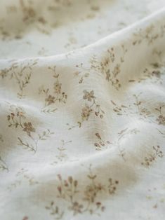 the fabric is white with brown flowers on it