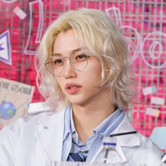 a person wearing glasses and a lab coat