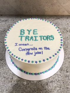 a white cake with blue and green frosting on it that says bye triators i mean congrats on the new job