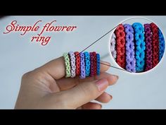 a hand holding a small stack of bracelets with the words simple flower ring on it