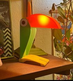 a lamp that is sitting on top of a wooden table next to a banana peel